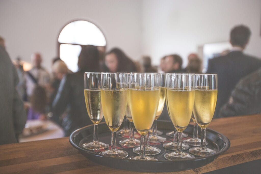 pexels-photo-16408 A sophisticated event with champagne glasses at a lively social gathering indoors.